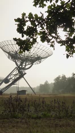 radio telescope in a field on a foggy day