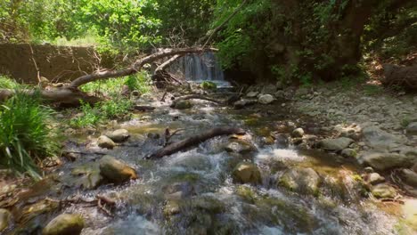 aerial: a small waterfall in a forest on samos island