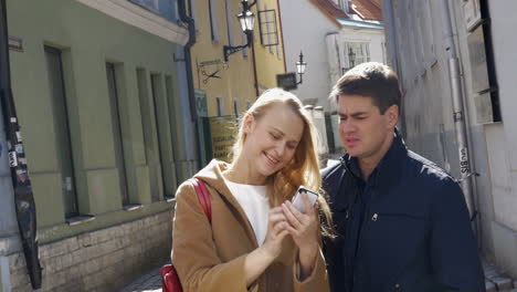 couple taking selfie with smartphone in tallinn