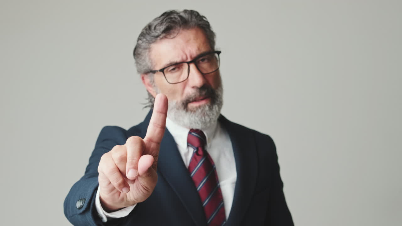 Serious Businessman Gesturing No with Finger
