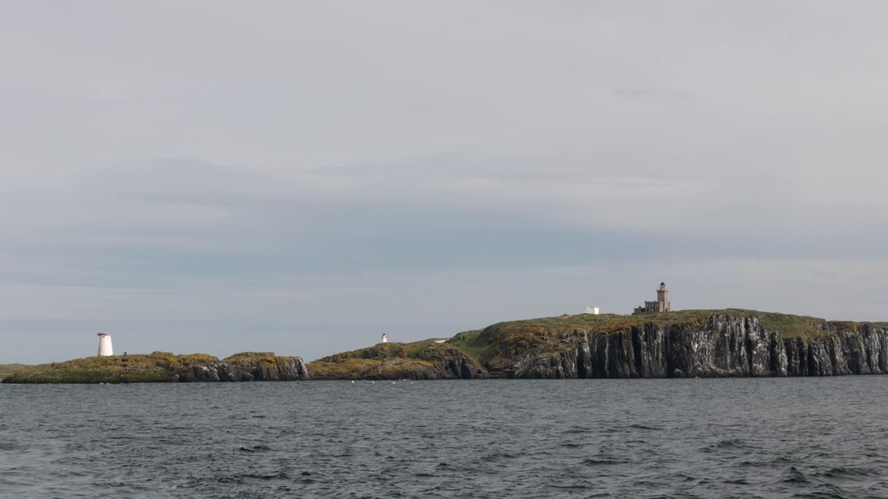 Medium shot sailing away from the famous Isle of May in Scotland