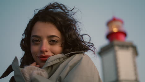 Dreamy-girl-rest-seaside-lighthouse-view-closeup.-Happy-romantic-woman-get-warm