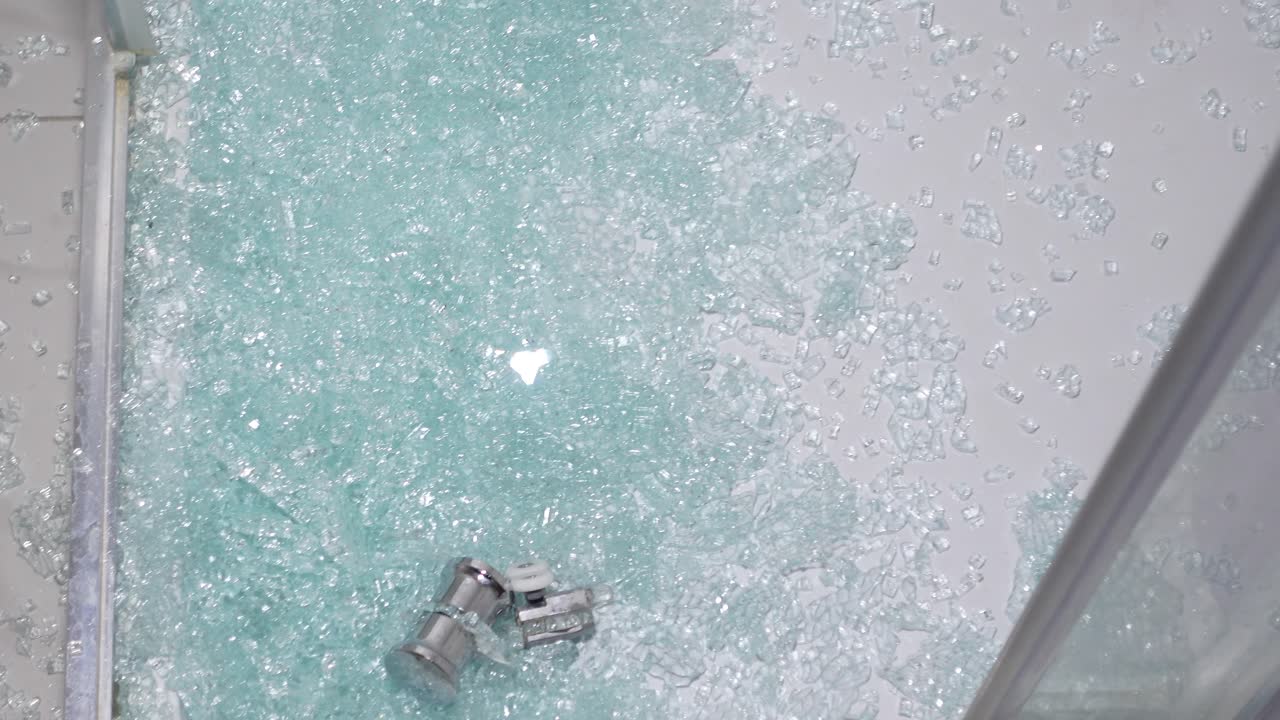 Shattered Glass on the Floor from a Broken Shower Enclosure