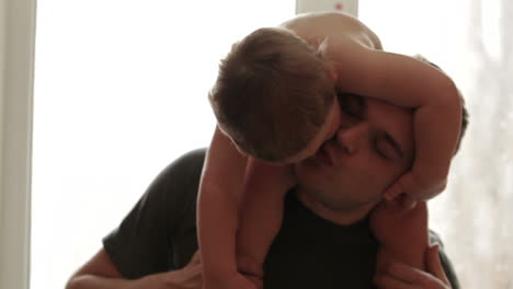 Two-year-old-son-is-sitting-on-the-father-shoulders