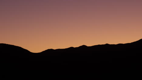 scenic summer sunset silhouette over the mountains in wellington, new zealand