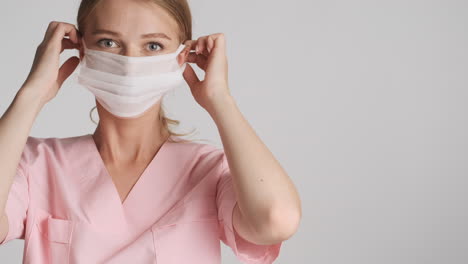 caucasian female doctor wearing medical mask.