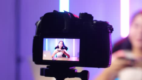 Display Camera Of Asian Kid Girl Holding Mobile Phone And Talking To Camera While Live Stream