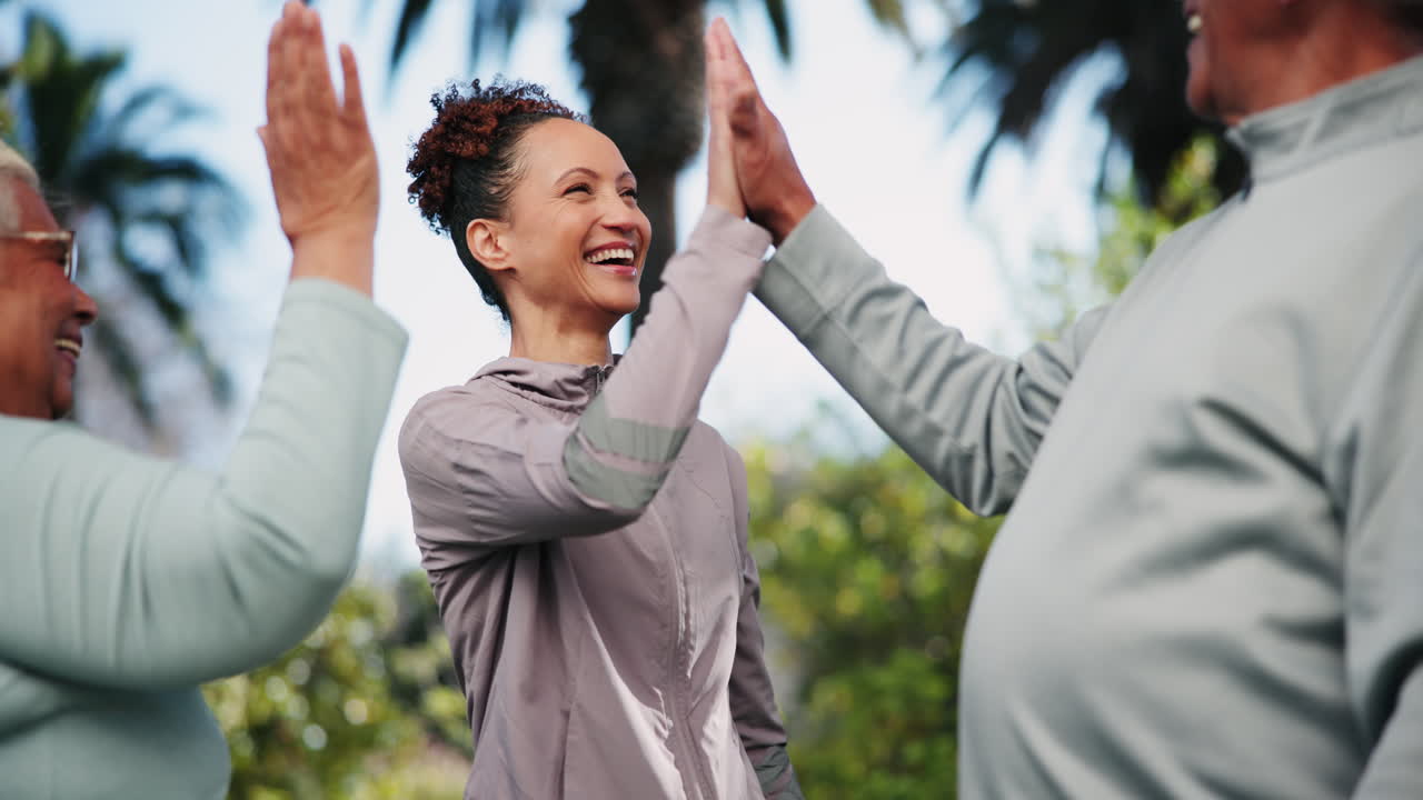 Group of people high fiving outdoors