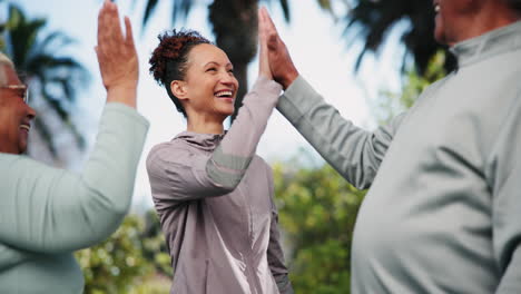 group of people high fiving outdoors