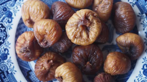 dried figs on a blue and white plate