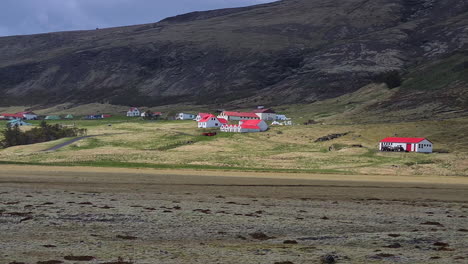 idyllic houses and farms in landscape of iceland, wide view