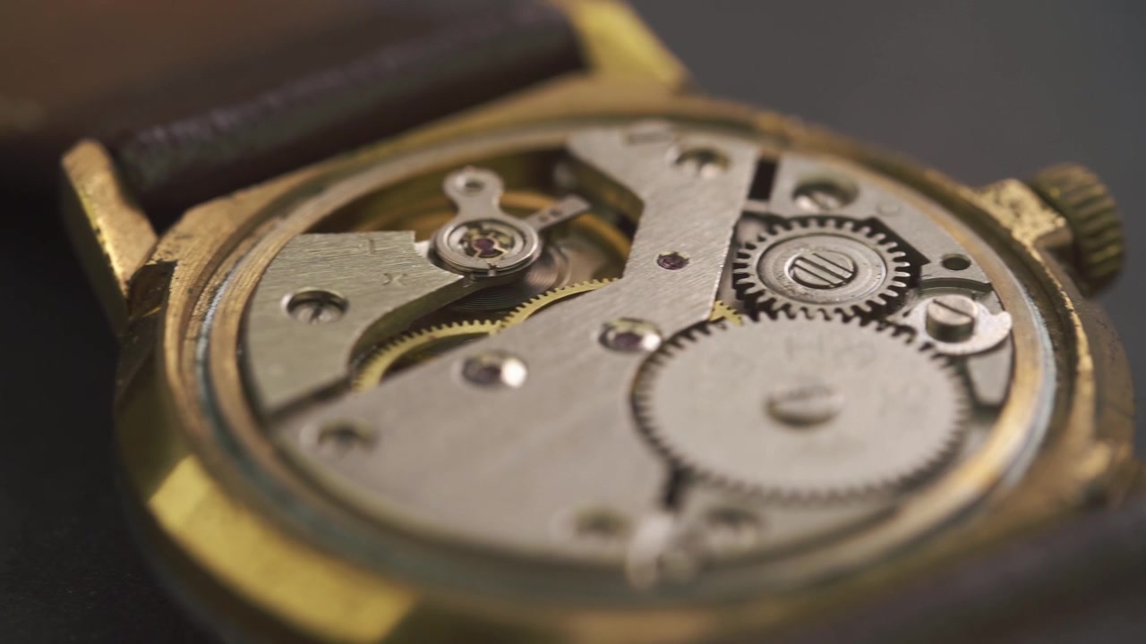 Close-up of an Old Mechanical Watch Movement with Ticking Gears