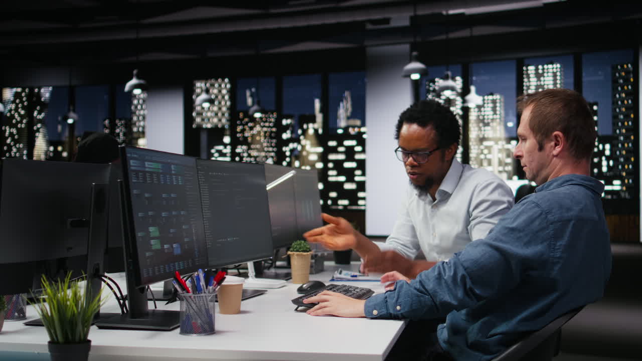 Diverse Businessmen Collaborating on Software Development in Night Office