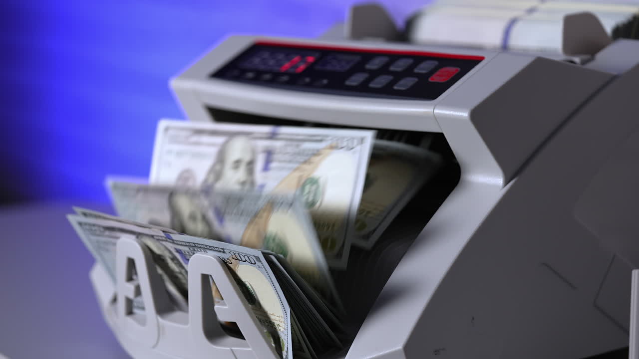 Banking modern counter with dollars. Money counting on special machine. Money and business concept. Cropped view