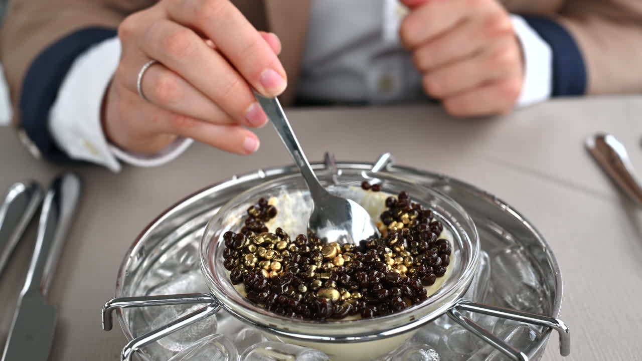 Woman eating a tiramisu desert with chocolate chunks at a restaurant