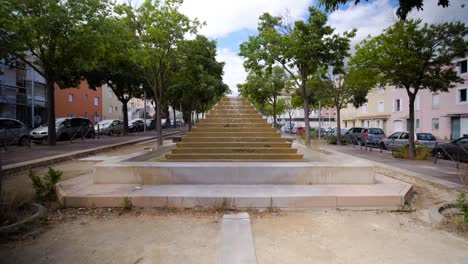 At-the-park,-a-magnificent-fountain-takes-center-stage,-its-sparkling-waters-gracefully-cascading-down-a-set-of-elegant-stairs