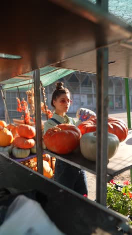 woman at a pumpkin market