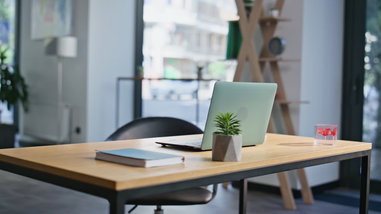 Modern coworking workspace laptop on wooden desk closeup. Organized work table