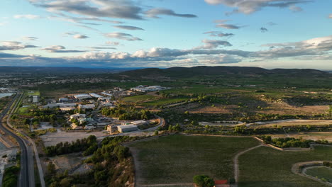 aerial shot next to balaruc les bains sunset vineyards with solar powered indust