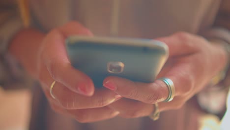 Hands-of-Young-African-American-Woman-on-Smartphone-Texting-Messages,-Close-Up-Detail-Full-Frame