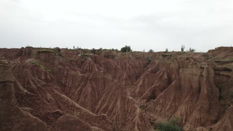 flying over red clay canyons on arid tatacoa desert in colombia