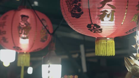 red lanterns and fluorescent lamps in street cafe in evening