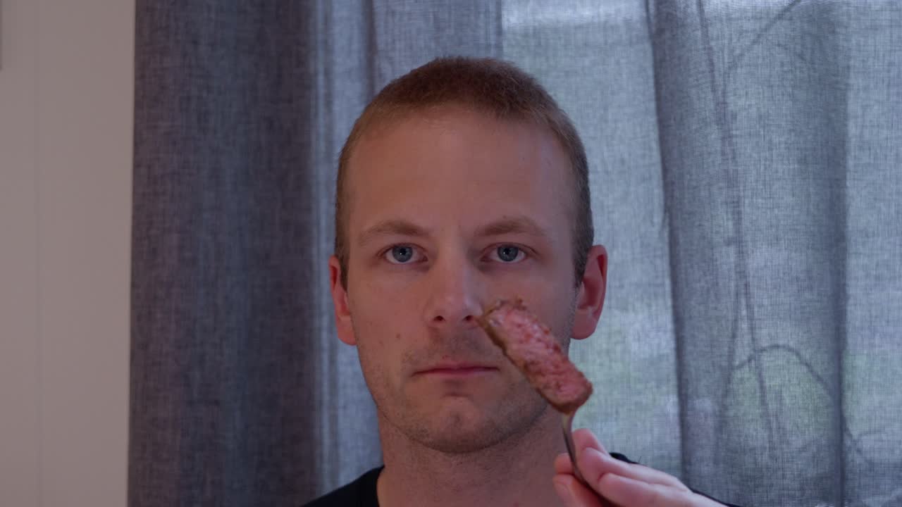 A man eating a meal indoors.