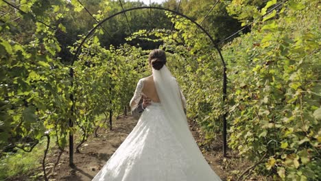 Lovely-newlyweds-caucasian-bride-embracing-groom-in-park-making-kiss,-wedding-couple-family-hugging