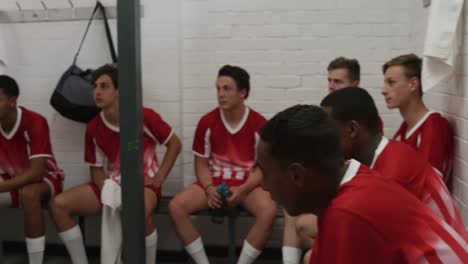 Coach-talking-to-rugby-players-in-the-locker-room