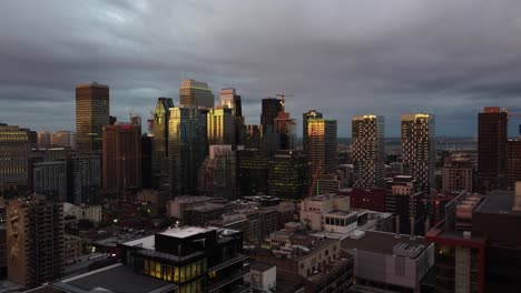 an approaching drone shot of skyscrapers in montreal, grey clouds