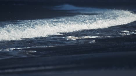 powerful waves break around the sandy beach in ersfjord