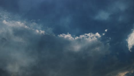 a thunderstorm that strikes the dark clouds in the blue sky