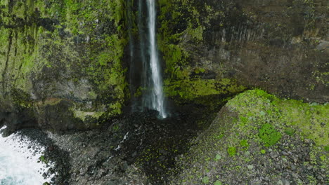 Drone-tilt-up-reveal-of-cascading-Veu-da-Noiva-waterfall-on-precipitous-cliff