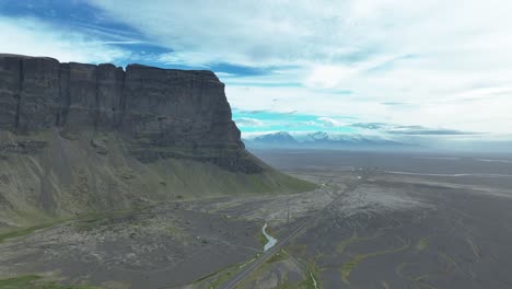 South-Iceland---A-Scenic-View-of-Lomagnupur-and-Ring-Road-with-Vatnajokull-Glacier-in-the-Background---Wide-Shot