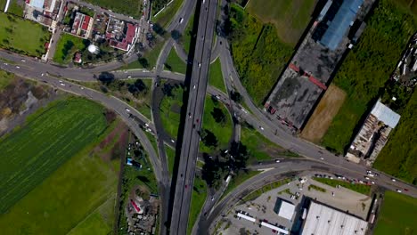 Top-Drohne-Blick-Auf-Eine-Kleeblatt-Kreuzung-Auf-Einer-Kleinen-Autobahn-In-Der-Charmanten-Stadt-Chalco,-Mexiko