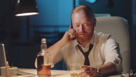 businessman drinking and working late night