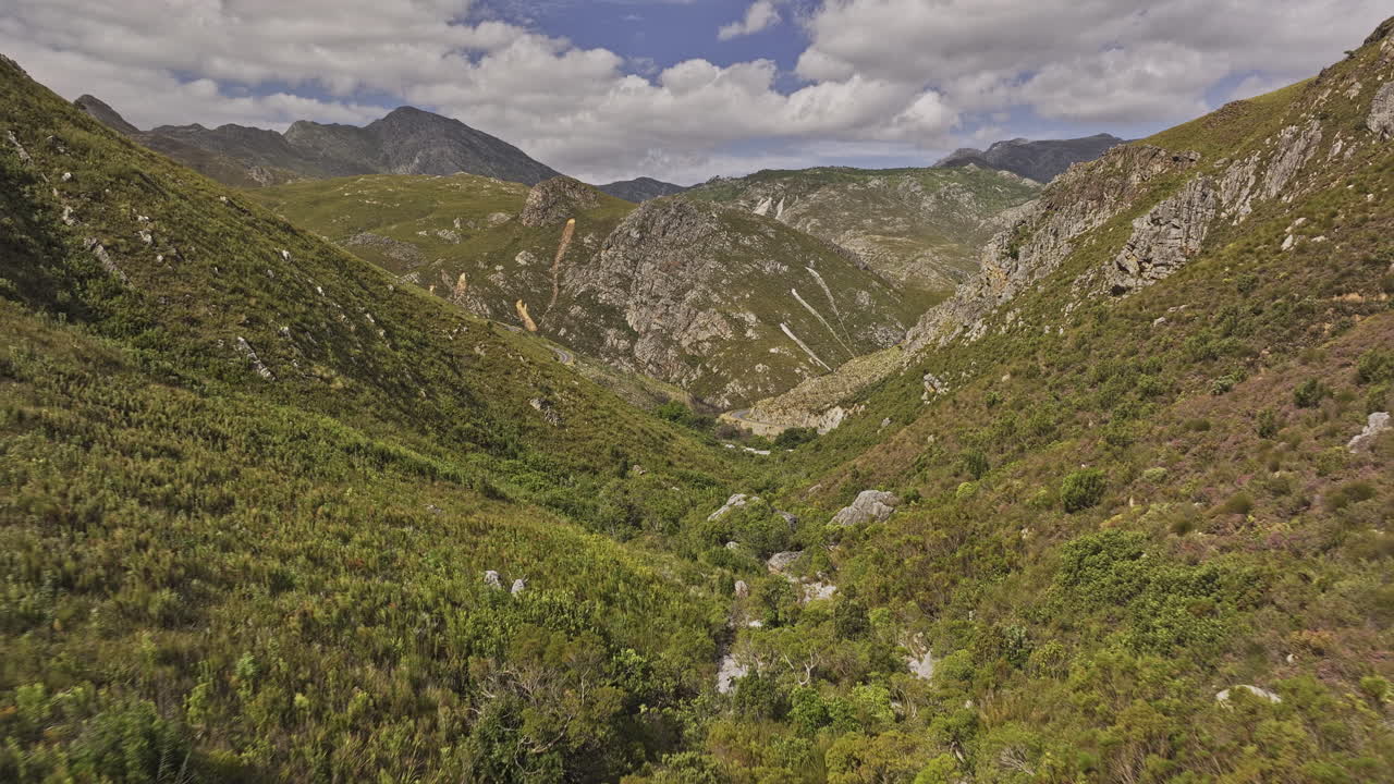 Franschhoek South Africa Aerial v22 flyover verdant valley capturing cars traverse through a winding Lambrechts road, surrounded by a mountainous landscape - Shot with Mavic 3 Pro Cine - Jan 6th 2024