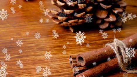 Animation-of-snow-falling-over-christmas-decorations-on-table