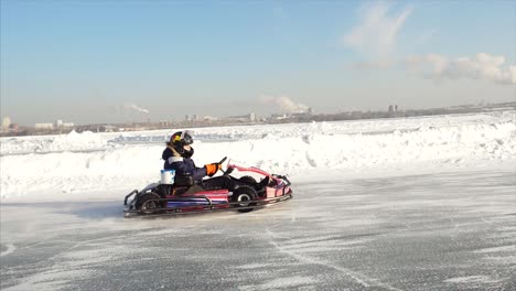 kid driving a go-kart on a frozen lake