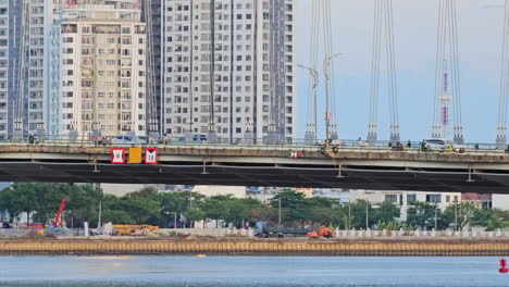 vehicles and people crossing bridge in danang vietnam cau tran thi ly