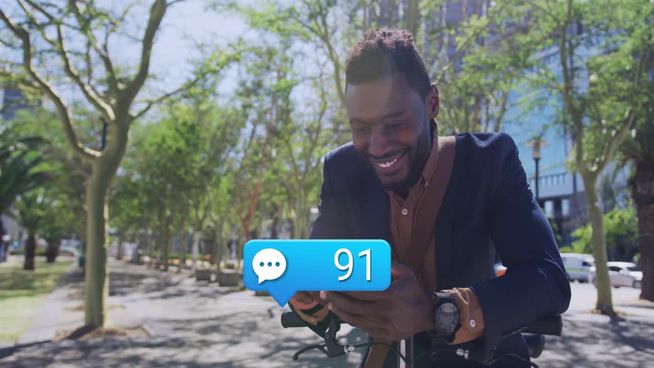 Man leaning on scooter, tapping device while blue chat count rising, smiling laughing from business