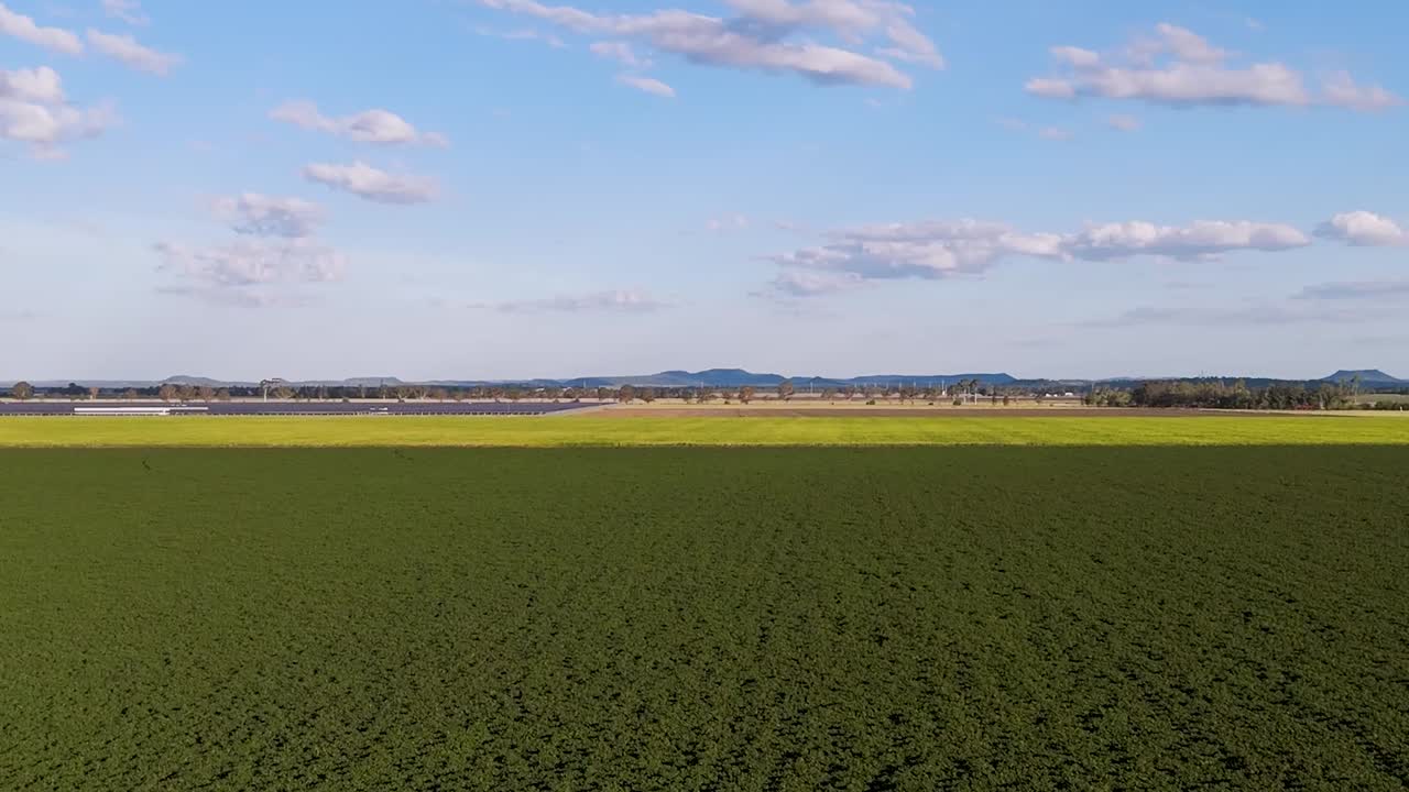 Expansive fields with solar panels and crops