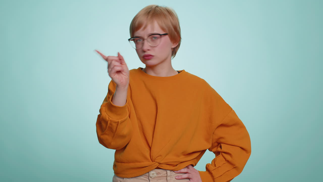 Attractive woman shakes finger and saying no be careful avoid danger mistake disapproval sign