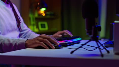 a gamer playing a video game at night in a dimly lit room.