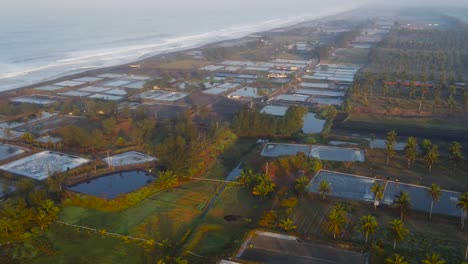 aerial forward over salt saline ponds, traditional production in indonesia