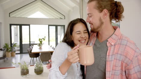 a diverse couple shares a cozy moment in a modern kitchen at home