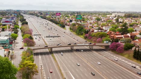 rotating drone revealing the large number of vehicles crossing the panamerican highway on the south american side