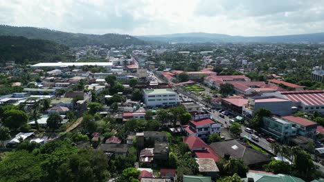 flying by buildings and traffic in legazpi city, albay, philippines