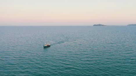 aerial 4k cinematic , fishing boat with nets in the water