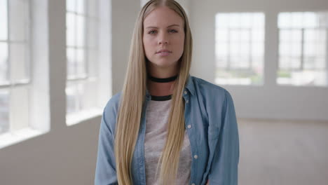 slow-motion-portrait-of-beautiful-young-blonde-woman-arms-crossed-looking-serious-pensive-at-camera-wearing-relaxed-stylish-fashion-in-new-apartment